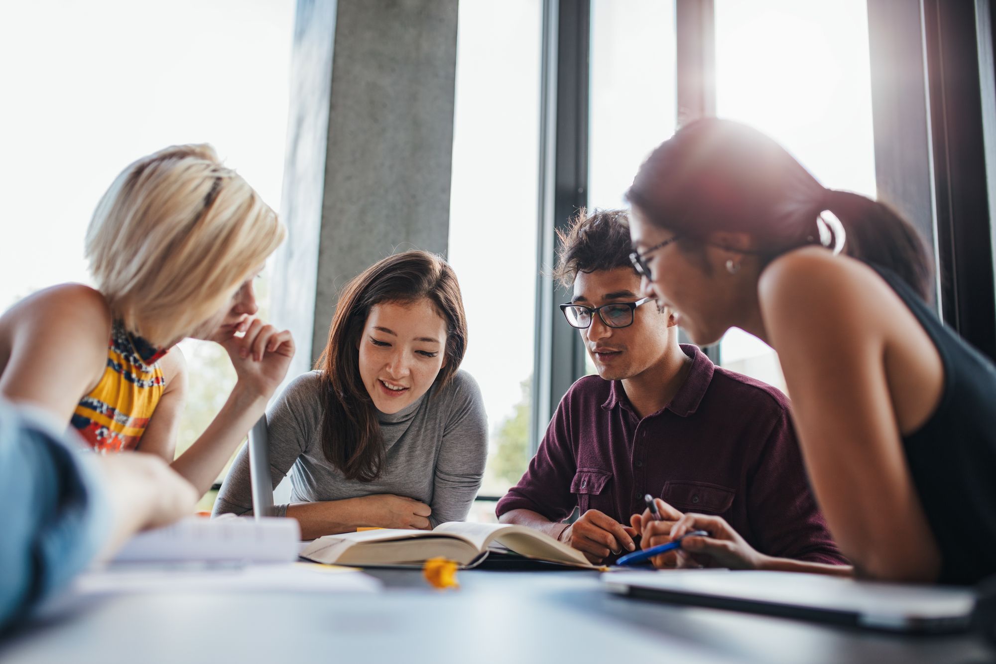 Students reading and discussing at a table